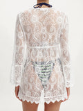 Back view of a woman wearing a white lace cover-up with bell sleeves, showing the intricate lace pattern.