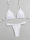 White triangle bikini top and ruched thong bottoms laid flat