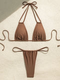 Brown triangle bikini top and thong bottom laid flat
