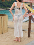 Back view of a woman wearing a white crochet knit maxi dress with a tie-back detail.