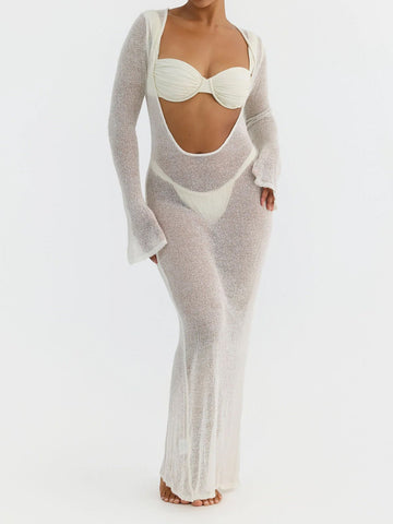 Woman wearing a white sheer knit maxi dress with long sleeves and a scoop neckline.