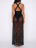 Woman wearing a black halter maxi dress with sheer lace overlay, front view