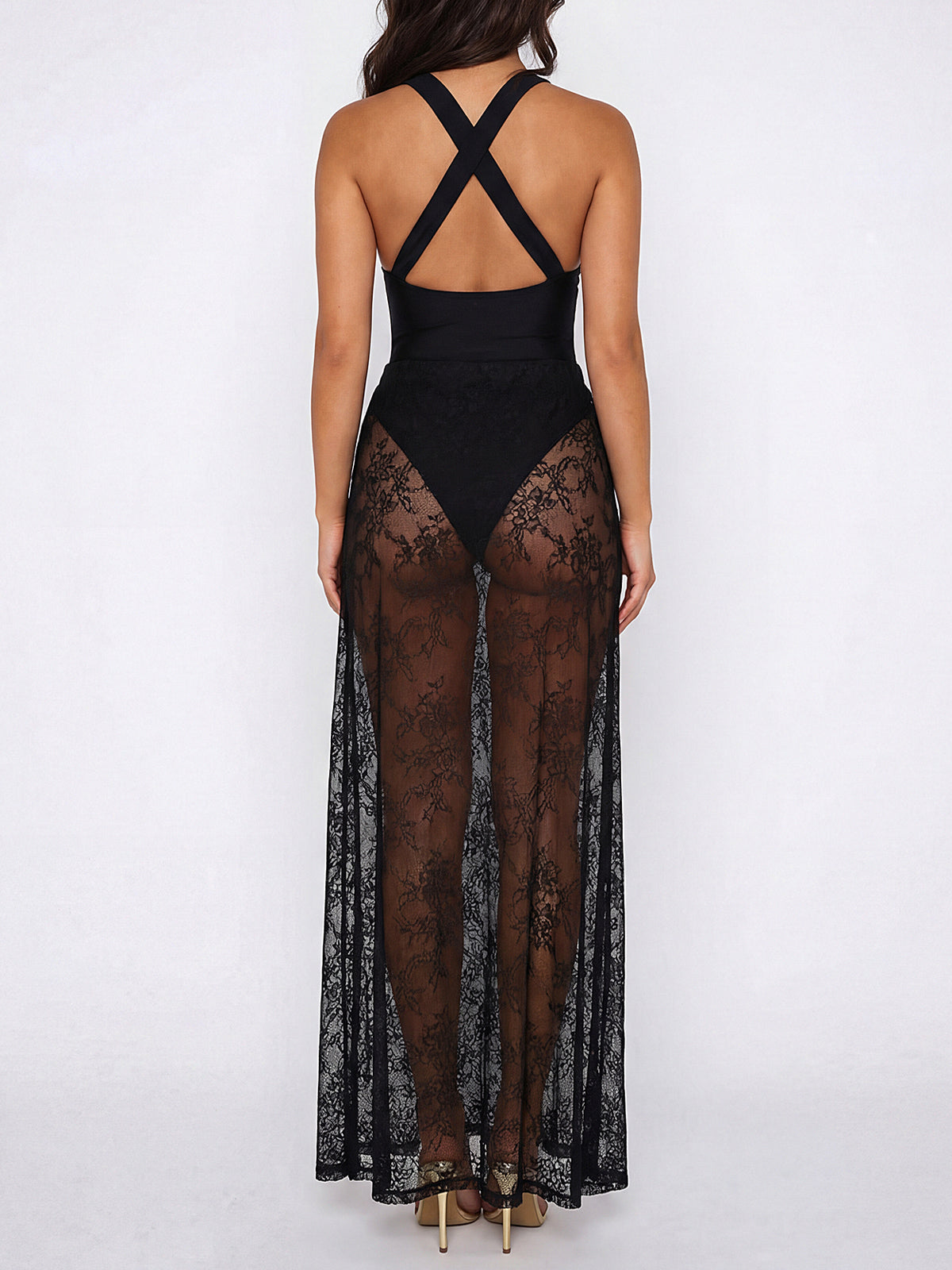 Woman wearing a black halter maxi dress with sheer lace overlay, front view