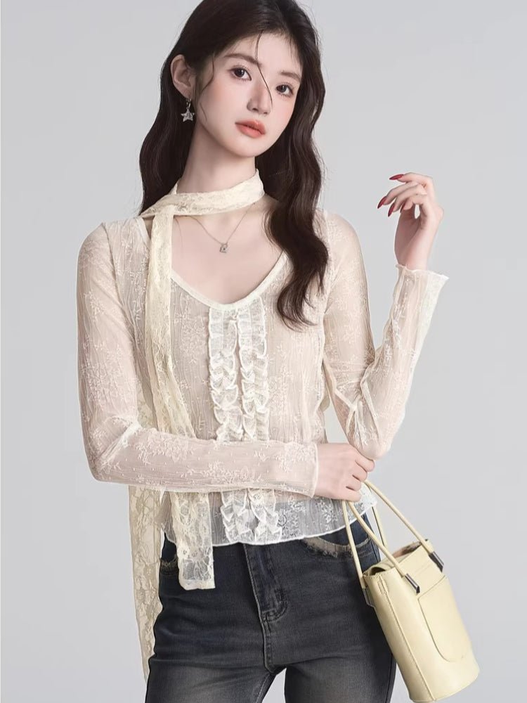 Cream lace top with ruffled front and scarf detail worn with jeans