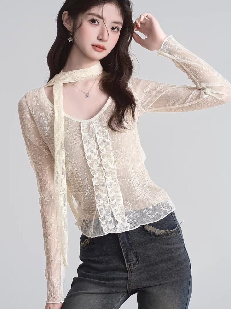 Close-up of the cream lace top's fabric and ruffle embellishments