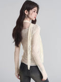 Back view of a cream lace long-sleeve top with a flowy scarf detail