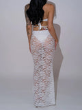 Back view of a woman wearing a white strapless bikini and a white lace maxi skirt