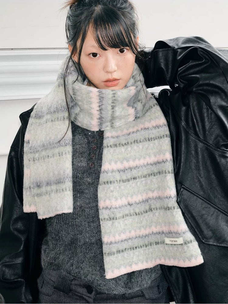 A young person wearing a light grey and pink striped knit scarf.