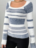 Front view of a woman in a blue and white striped fuzzy knit top with a scoop neck.