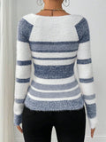 Back view of a woman in a blue and white striped fuzzy knit sweater.