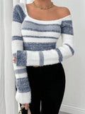 Woman showcasing the off-the-shoulder styling of a blue and white striped fuzzy knit top.