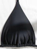 Close-up of black triangle bikini top fabric