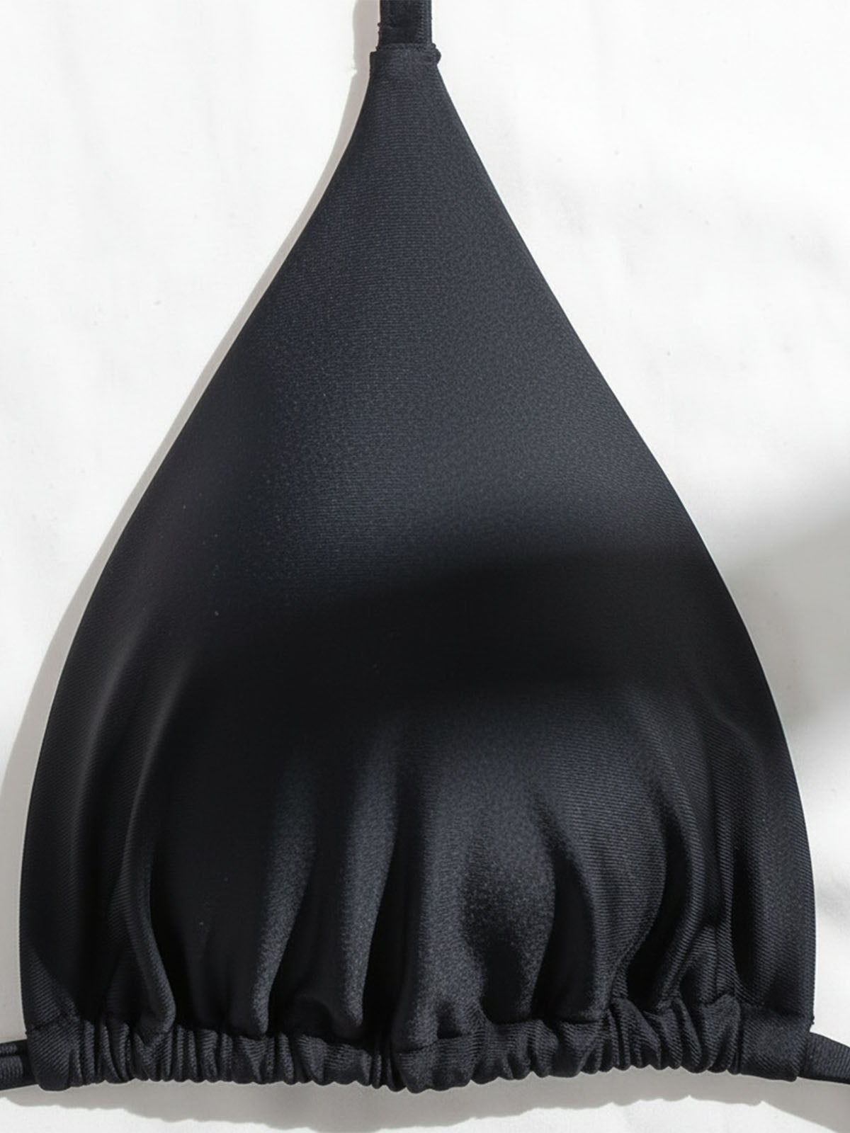Close-up of black triangle bikini top fabric