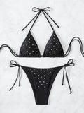 Flat lay of a black embellished triangle bikini set with adjustable ties