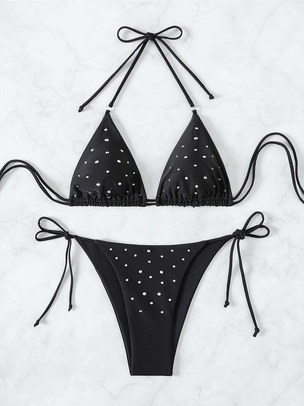 Flat lay of a black embellished triangle bikini set with adjustable ties