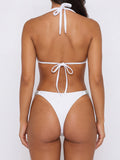 Back view of white triangle bikini top with adjustable ties and bikini bottom with embellished sides