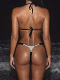 Rear view of woman in a black textured bikini set with a jeweled thong bottom.