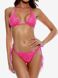 Woman wearing a hot pink sequined halter bikini with tie-side bottoms