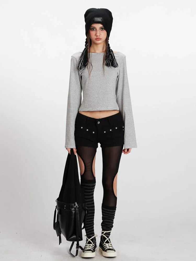 Model wearing a grey and white striped long-sleeve cropped top with bell sleeves and black shorts