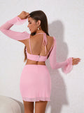 Back view of a woman in a pink two-piece set with long sleeves.