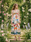 Woman wearing a white midi dress with a tropical print, posing in a garden with roses.