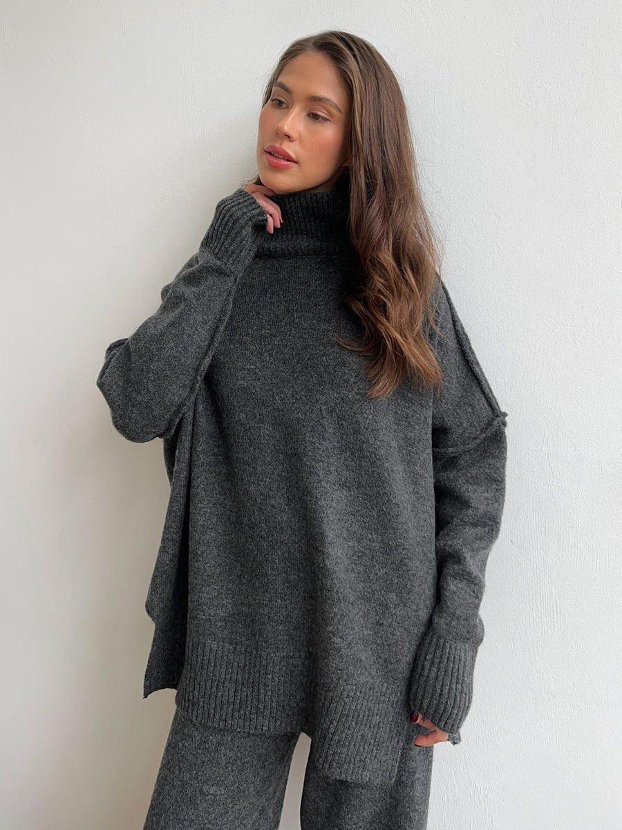 Woman wearing a charcoal knit turtleneck sweater and wide leg pants from the back