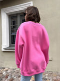 Back view of a woman in a pink oversized sweatshirt.