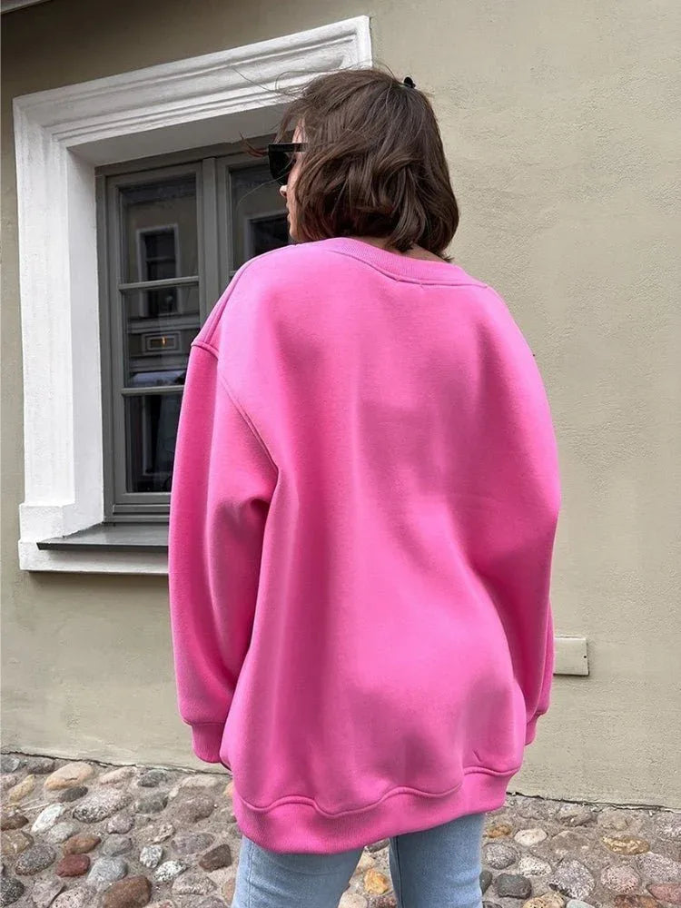 Back view of a woman in a pink oversized sweatshirt.