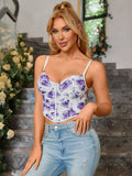 Front view of a woman posing in a white and purple floral print ruched cropped top with spaghetti straps.