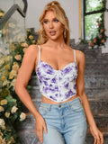 Side profile of a woman wearing a white and purple floral print ruched cropped top with spaghetti straps.