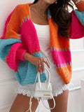 Woman wearing a colorful knit cardigan with dropped shoulders and long sleeves
