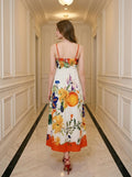 Back view of a woman in a floral print midi dress with spaghetti straps.