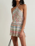 Woman wearing a colorful chevron knit halter mini dress with a side slit