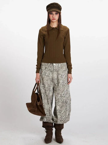 Model wearing a brown long-sleeve knit top with a collared neckline, paired with patterned pants.