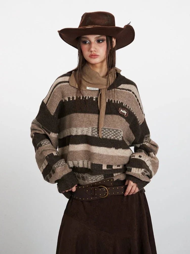 Woman posing in a striped knit sweater, brown skirt, and cowboy hat