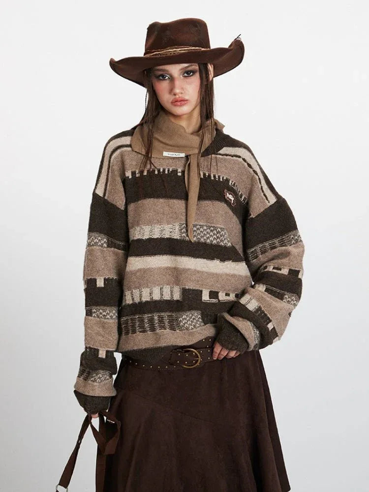 Close-up of a woman wearing a striped knit sweater with a scarf and cowboy hat