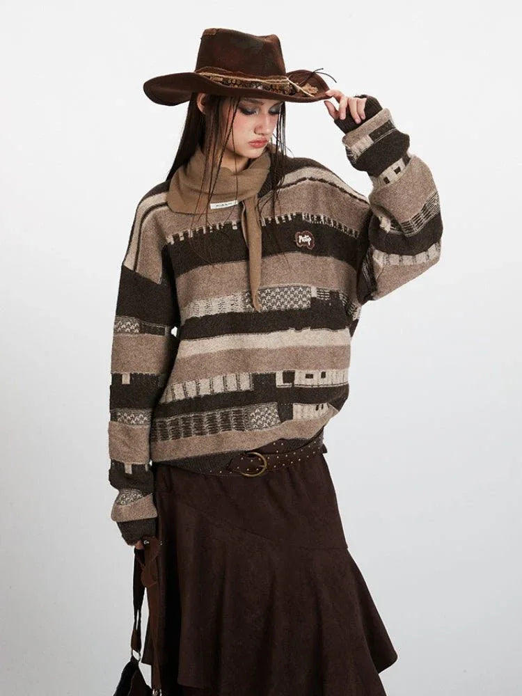 Woman adjusting her cowboy hat while wearing a striped knit sweater
