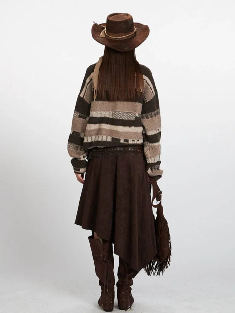 Back view of a woman in a striped knit sweater and a brown skirt