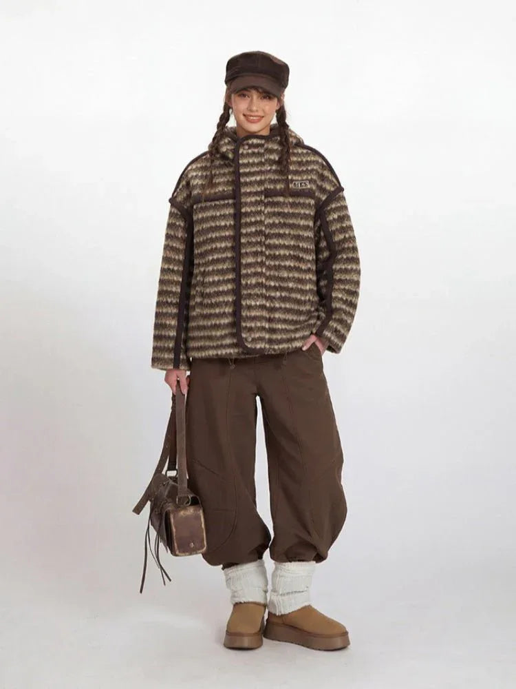 Model wearing a brown and beige striped fleece jacket with a hood.