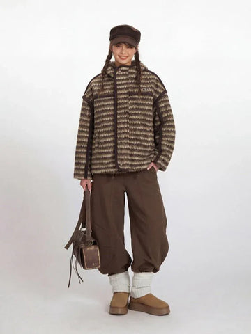 Model wearing a brown and beige striped fleece jacket with a hood.