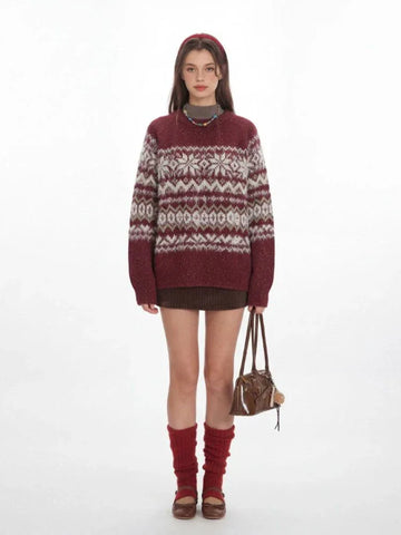 Woman wearing a burgundy knit sweater with a Fair Isle pattern and crew neck.