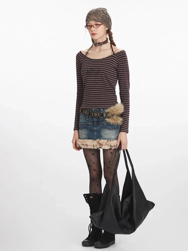 Full-body shot of a woman styled in a striped top, denim skirt, and accessories