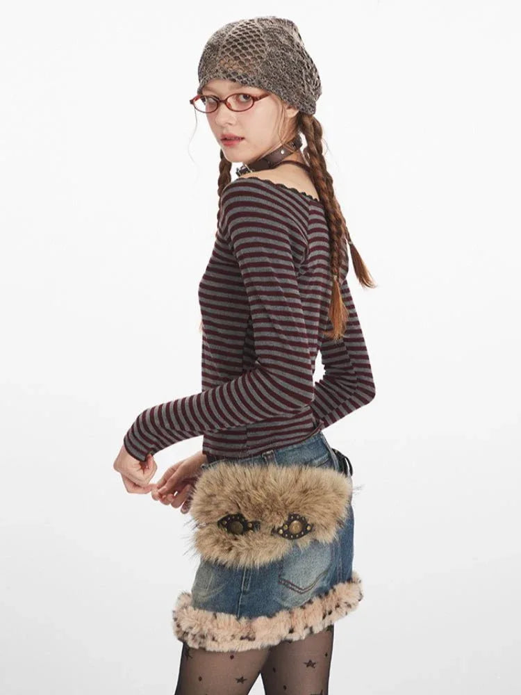 Side profile of a woman wearing a striped off-the-shoulder top and denim skirt