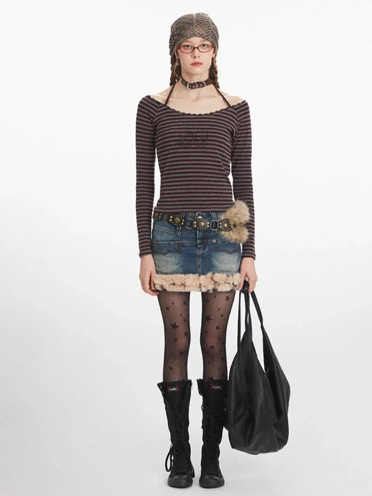 Woman wearing a striped off-the-shoulder long-sleeve top with a denim skirt and black boots