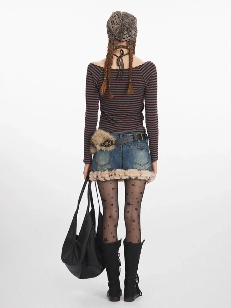 Woman wearing a striped off-the-shoulder long-sleeve top with a denim skirt and black boots