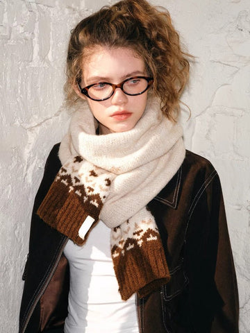 Model wearing a cream and brown Fair Isle knit scarf with a textured finish.
