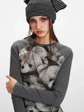 Detailed view of the teddy bear print on the grey long-sleeve top.