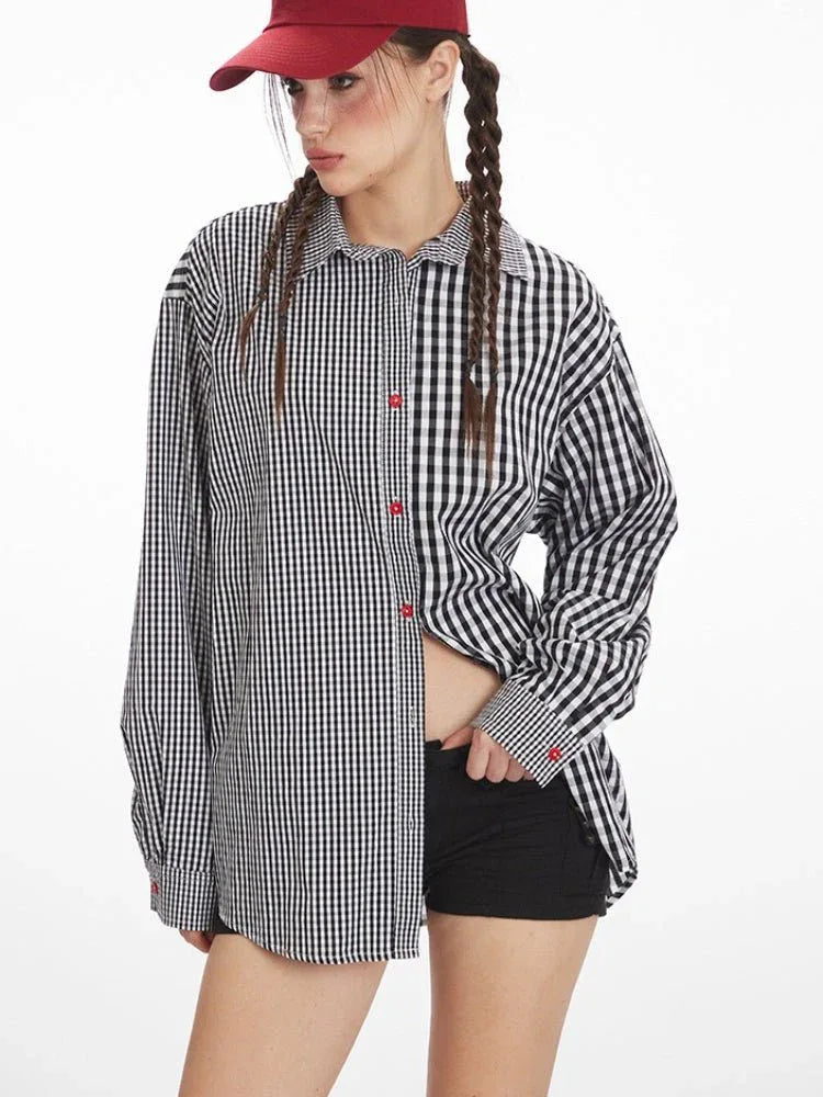 Front view of a woman wearing an oversized black and white gingham shirt with a contrasting pattern, red buttons, and a red belt, with one hand inside her shorts.