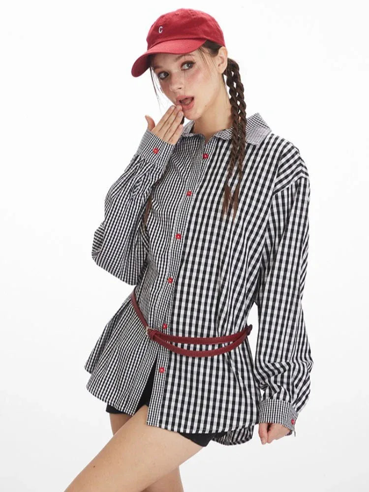 Close-up of a woman wearing an oversized black and white gingham shirt with red buttons, showing off the asymmetrical pattern and collar.