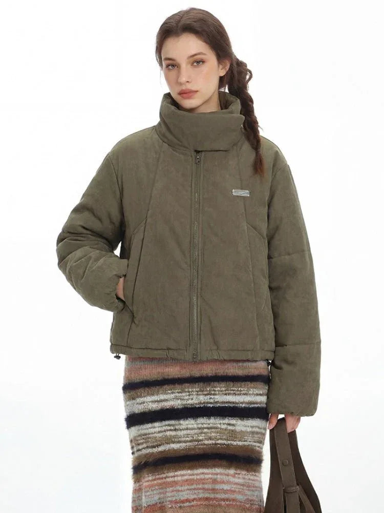 Detailed shot of the woman's face and the collar of the green puffer jacket.